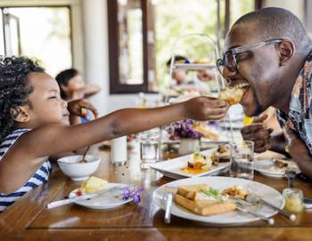 father and daughter eating breakfast