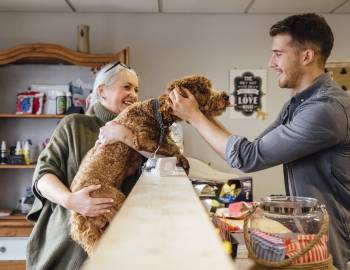 person with their dog in a dog supply shop