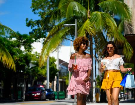 two women walking outside at outdoor shopping area