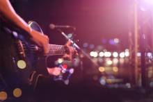 person playing guitar on stage