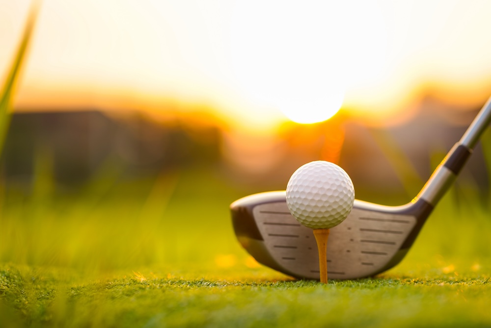 close up on golf ball and club 